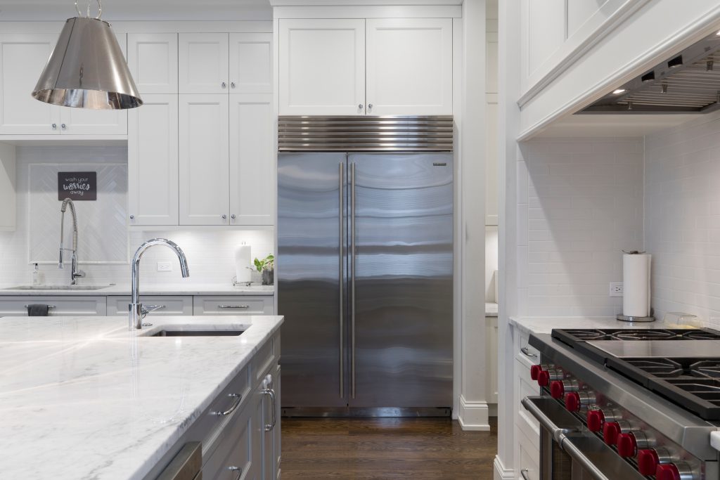 refrigerator and white kitchen cabinets
